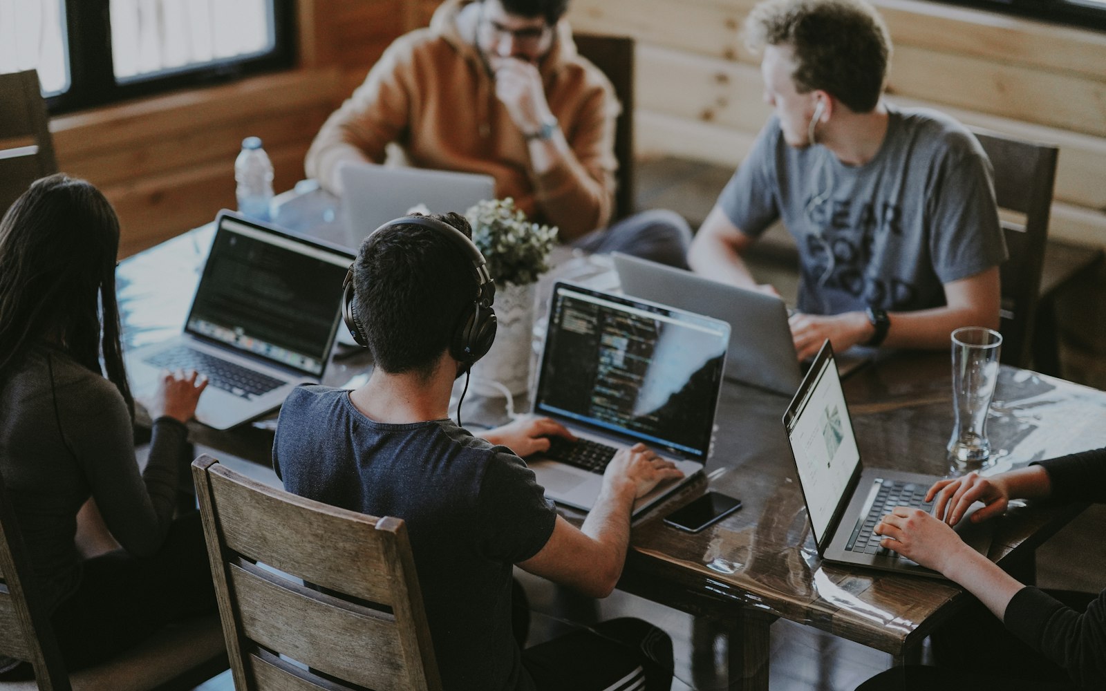 A team working together around laptops